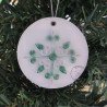 Quilled green and white star Christmas tree ornament on a three inch clear acrylic disk by Rolling Blossoms