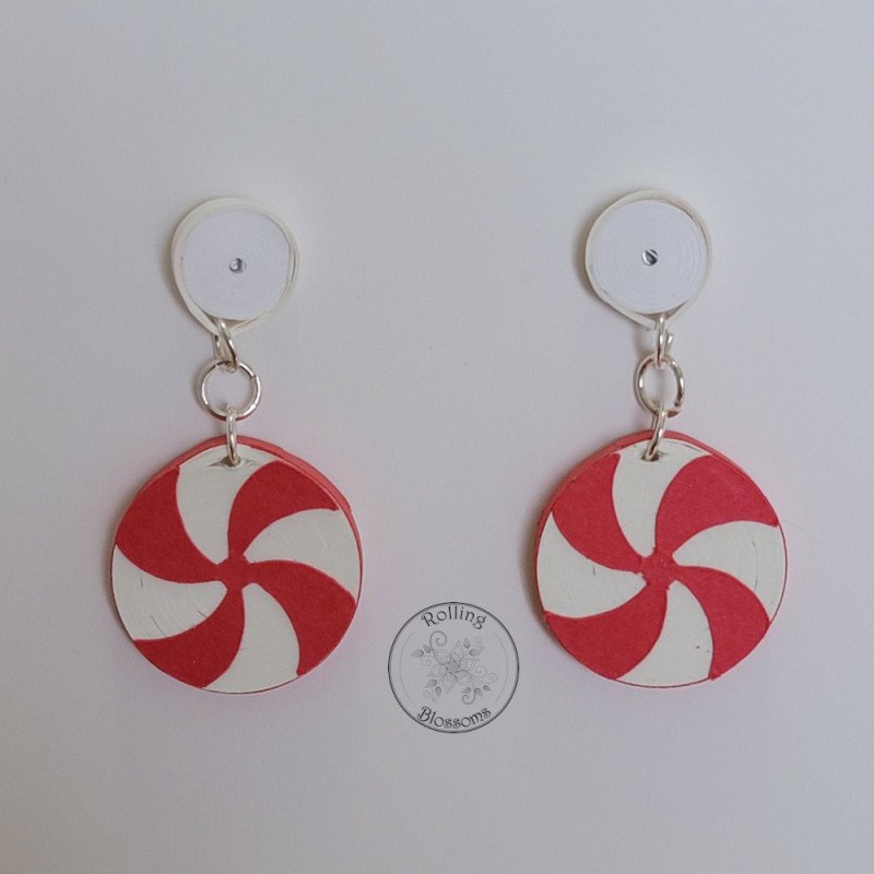 Quilled red peppermint stud earrings with white post by rolling blossoms. Quilled red peppermint stud earrings with white post by rolling blossoms.